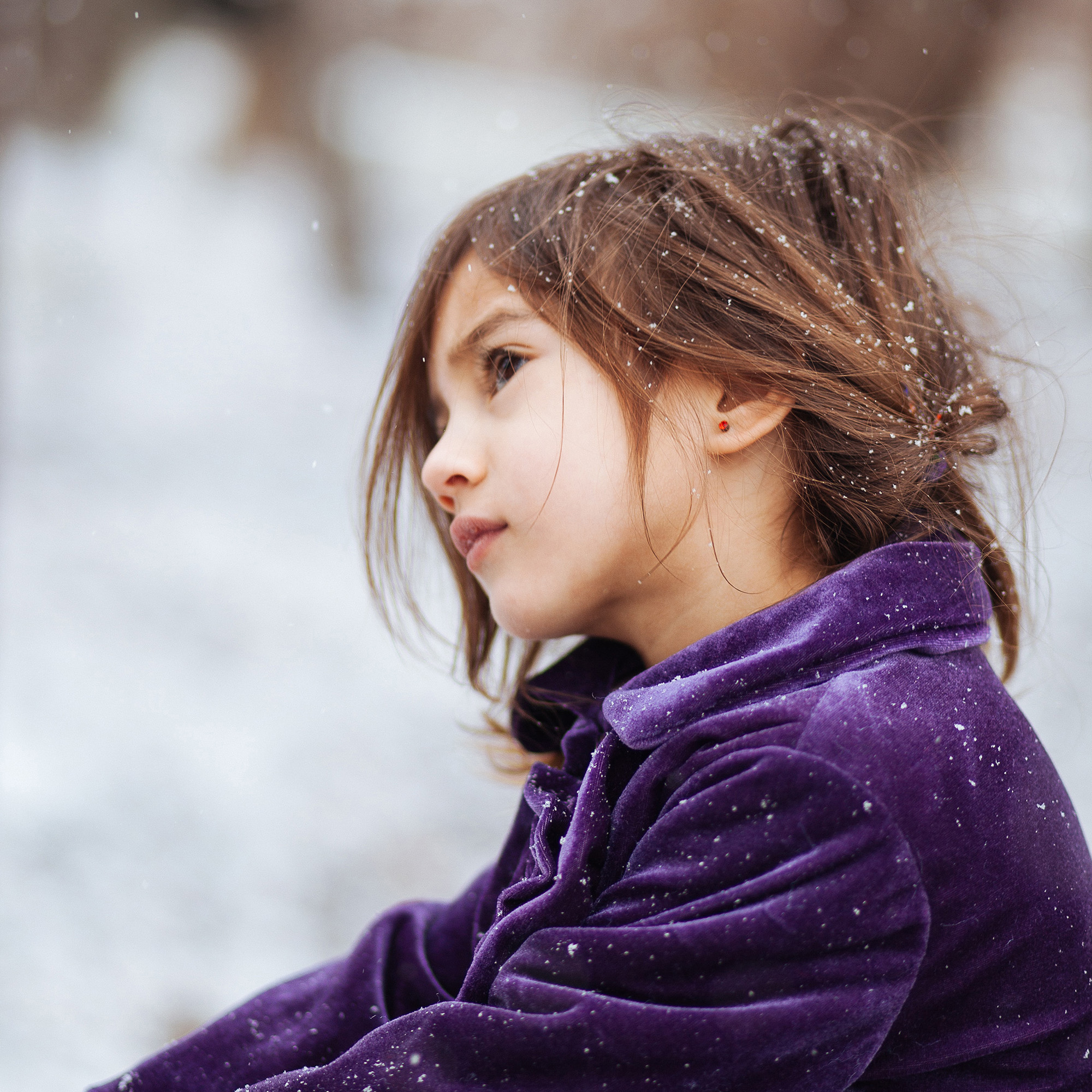 Girl in purple sweater in the snow