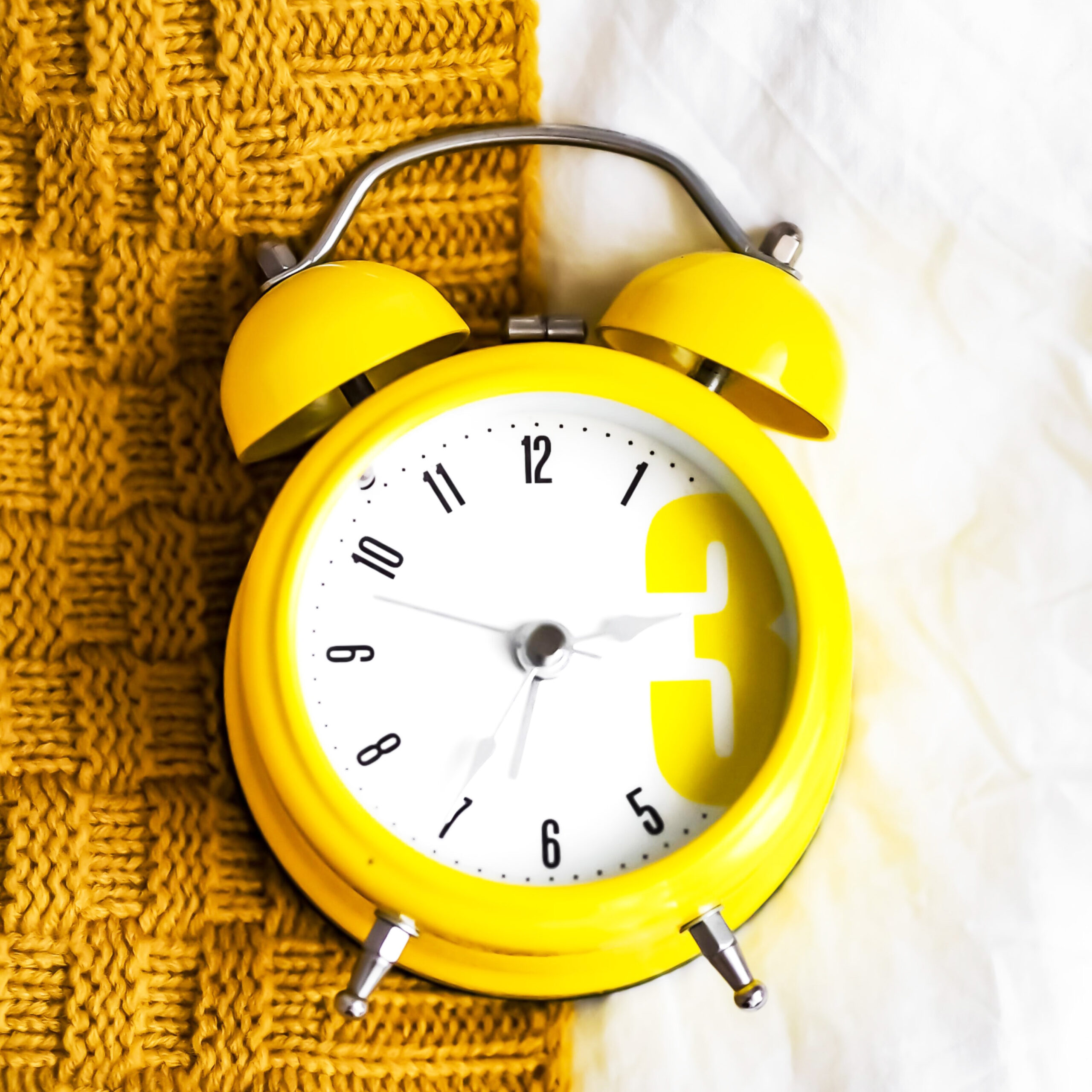Yellow alarm clock on a table by Laura Chouette via Unsplash